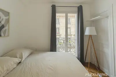 Un ou plusieurs lits dans un hébergement de l'établissement Flexliving - Room - Lamarck