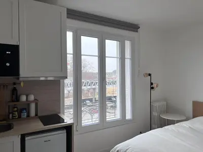 Un ou plusieurs lits dans un hébergement de l'établissement Studio Plein Soleil Seine