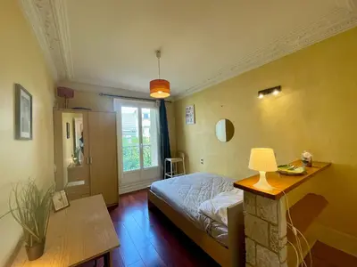 Un ou plusieurs lits dans un hébergement de l'établissement Appartement Convention 5 Paris