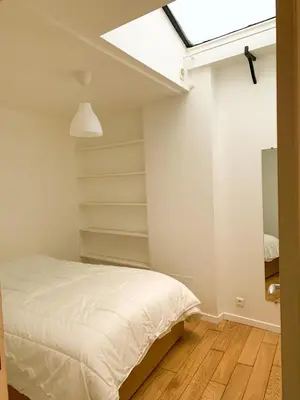Un ou plusieurs lits dans un hébergement de l'établissement GRAND APPARTEMENT Paris 10