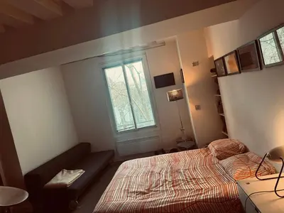Un ou plusieurs lits dans un hébergement de l'établissement Suite indépendante studio top centre Marais