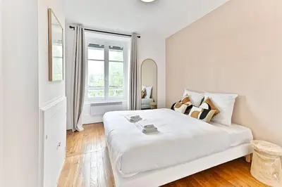 Un ou plusieurs lits dans un hébergement de l'établissement Appartement Spacieux Vue sur Paris Boulogne