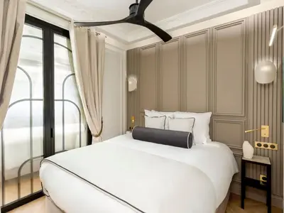 Un ou plusieurs lits dans un hébergement de l'établissement Merveil - Signature Suite -Tour Eiffel-Grenelle II