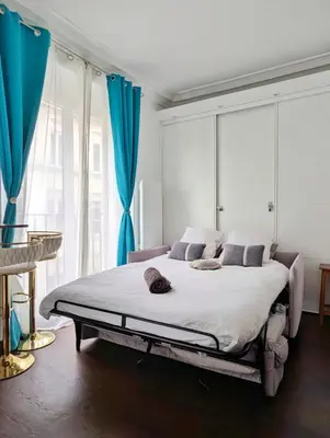 Un ou plusieurs lits dans un hébergement de l'établissement L'appartement du duc de Choiseul - Coeur Opéra