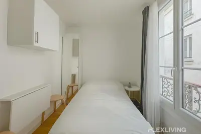 Un ou plusieurs lits dans un hébergement de l'établissement Flexliving - Studio - Étienne Marcel