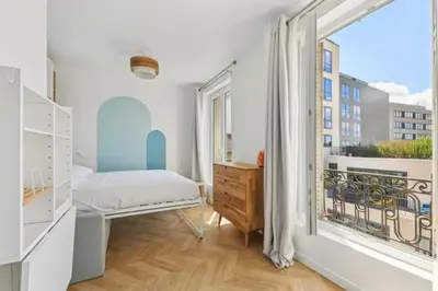 Un ou plusieurs lits dans un hébergement de l'établissement Studio cosy aux portes de Paris