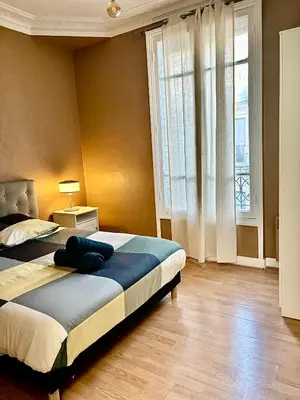 Un ou plusieurs lits dans un hébergement de l'établissement Guest House Tour Eiffel Paris