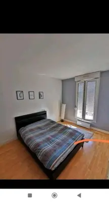 Un ou plusieurs lits dans un hébergement de l'établissement appartement cosy porte de Paris