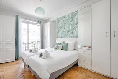 Un ou plusieurs lits dans un hébergement de l'établissement Le Petit Hôtel - Appt 6p 127 m² à Paris