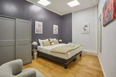 Un ou plusieurs lits dans un hébergement de l'établissement Sublim Apartment 3 bedrooms Center of Paris by Studio Prestige