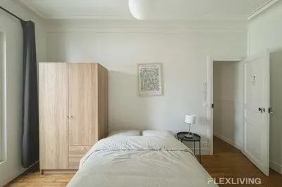 Un ou plusieurs lits dans un hébergement de l'établissement Cozy Room in Alésia Paris 14th