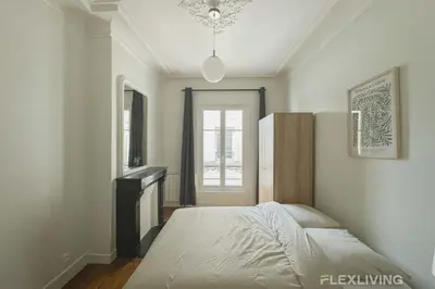 Un ou plusieurs lits dans un hébergement de l'établissement Cozy Room in Alésia Paris 14th