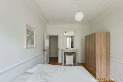 Un ou plusieurs lits dans un hébergement de l'établissement Spacieux appartement de 4 chambres à Paris 14 - Alésia