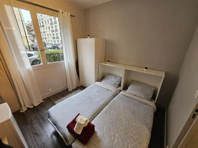 Un ou plusieurs lits dans un hébergement de l'établissement Cosy Paris Boulogne billancourt Rolland Garros PSG