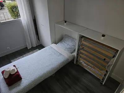 Un ou plusieurs lits dans un hébergement de l'établissement Cosy Paris Boulogne billancourt Rolland Garros PSG
