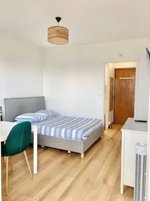 Un ou plusieurs lits dans un hébergement de l'établissement Cosy studio Balcon Paris Montparnasse