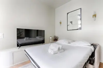 Un ou plusieurs lits dans un hébergement de l'établissement Appartement de charme 1BR Condorcet Saint-Georges