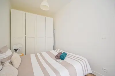 Un ou plusieurs lits dans un hébergement de l'établissement Appartement Suite Truffaut