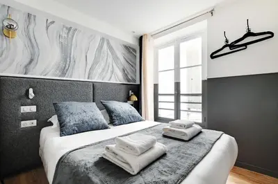 Un ou plusieurs lits dans un hébergement de l'établissement Cosy Studio with Air Conditioning -Near Montmartre