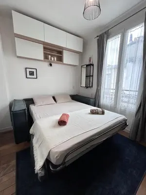 Un ou plusieurs lits dans un hébergement de l'établissement Charmant studio Paris 5e