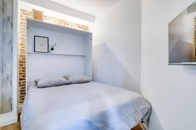 Un ou plusieurs lits dans un hébergement de l'établissement Le studio Duret II
