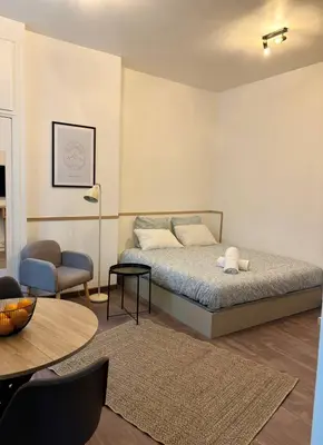 Un ou plusieurs lits dans un hébergement de l'établissement Cozy Studio