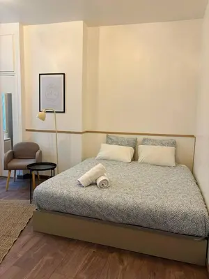 Un ou plusieurs lits dans un hébergement de l'établissement Cozy Studio