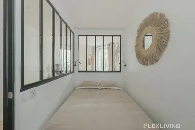 Un ou plusieurs lits dans un hébergement de l'établissement Flexliving - studio - Guénot
