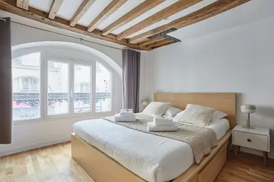 Un ou plusieurs lits dans un hébergement de l'établissement Charming Apartment Center of Paris By Studio Prestige