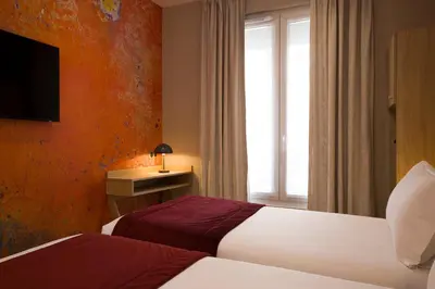 Un ou plusieurs lits dans un hébergement de l'établissement Hotel Charlemagne