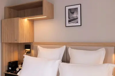 Un ou plusieurs lits dans un hébergement de l'établissement Hotel Charlemagne