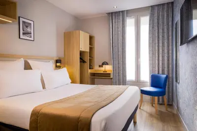 Un ou plusieurs lits dans un hébergement de l'établissement Hotel Charlemagne