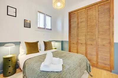 Un ou plusieurs lits dans un hébergement de l'établissement Luminous Apartment