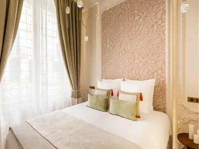 Un ou plusieurs lits dans un hébergement de l'établissement Merveil - Signature Suite-Champs Elysees- Marignan