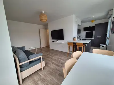 Télévision ou salle de divertissement dans l'établissement Appartement Les Portes du Stade
