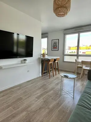 Télévision ou salle de divertissement dans l'établissement Appartement Les Portes du Stade