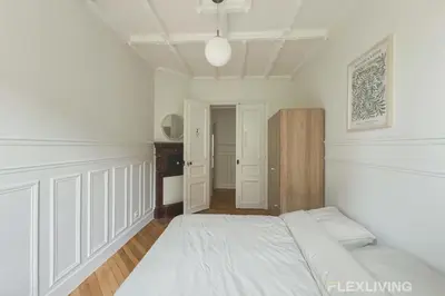 Un ou plusieurs lits dans un hébergement de l'établissement Cozy Room in Alésia Paris 14th