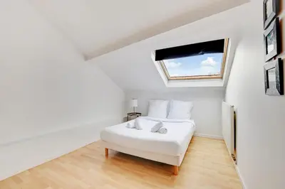 Un ou plusieurs lits dans un hébergement de l'établissement MALAKOFF - Cosy apartment L002