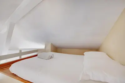 Un ou plusieurs lits dans un hébergement de l'établissement MALAKOFF - Cosy apartment L002