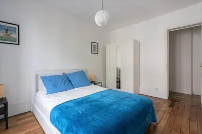 Un ou plusieurs lits dans un hébergement de l'établissement GuestReady - Beau Séjour près du Buttes-Chaumont