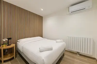 Un ou plusieurs lits dans un hébergement de l'établissement Appartement Climatisé Porte Versailles