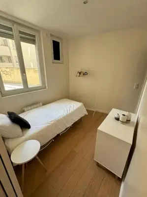 Un ou plusieurs lits dans un hébergement de l'établissement Charmant Appartement Alésia