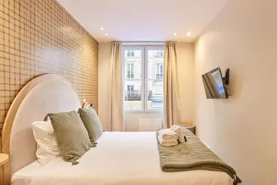 Un ou plusieurs lits dans un hébergement de l'établissement Charming flat in the heart of Paris
