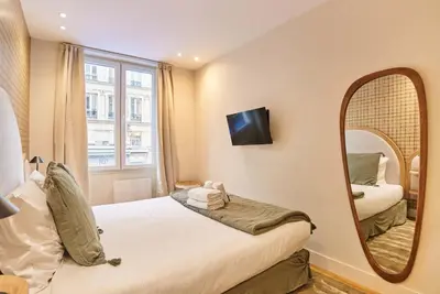 Un ou plusieurs lits dans un hébergement de l'établissement Charming flat in the heart of Paris