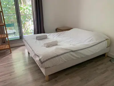 Un ou plusieurs lits dans un hébergement de l'établissement Cosy family flat