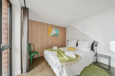 Un ou plusieurs lits dans un hébergement de l'établissement Lofts Chemin Vert