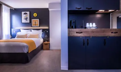 Un ou plusieurs lits dans un hébergement de l'établissement Best Western Plus Suitcase Paris La Défense