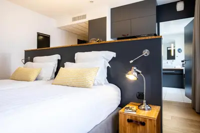 Un ou plusieurs lits dans un hébergement de l'établissement Best Western Plus Suitcase Paris La Défense