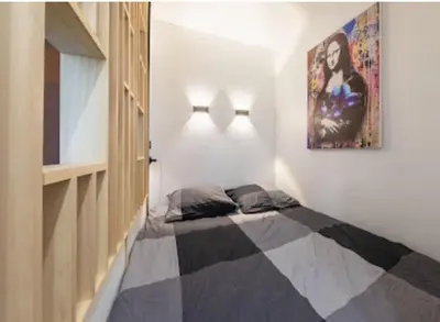 Un ou plusieurs lits dans un hébergement de l'établissement Cocon design et cosy à La Défense, vue imprenable sur Paris