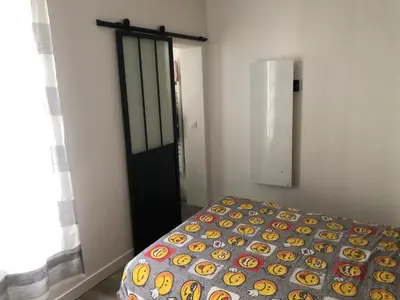 Un ou plusieurs lits dans un hébergement de l'établissement Appartement Paris Alésia Montparnasse